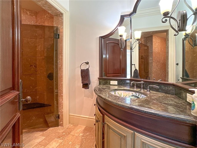 bathroom with crown molding, vanity, and walk in shower