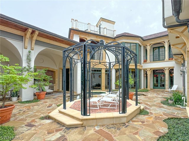 view of patio / terrace featuring french doors and a balcony