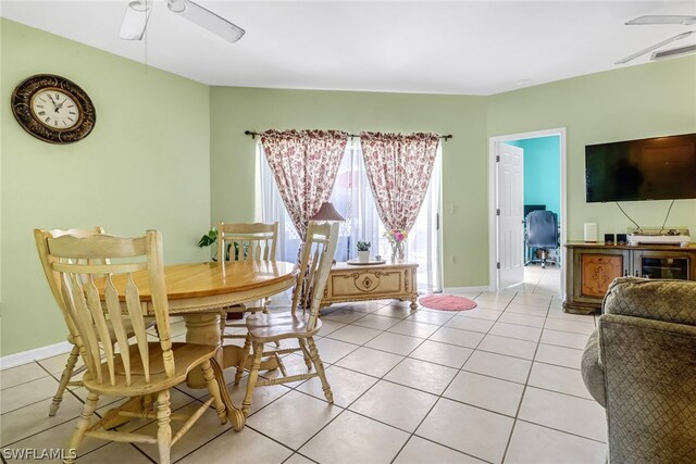 tiled dining area featuring ceiling fan