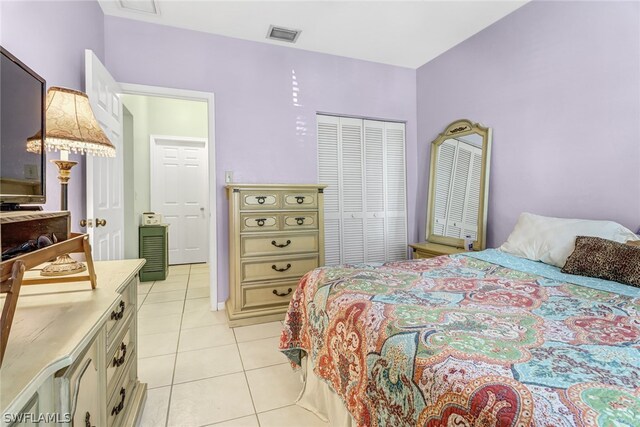 bedroom with light tile patterned floors and a closet