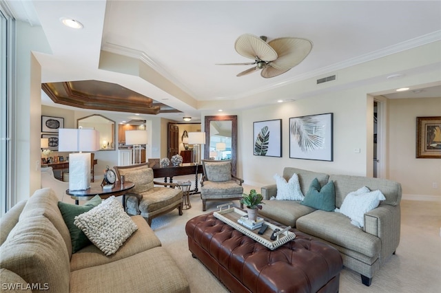 living room featuring ceiling fan, light colored carpet, and crown molding