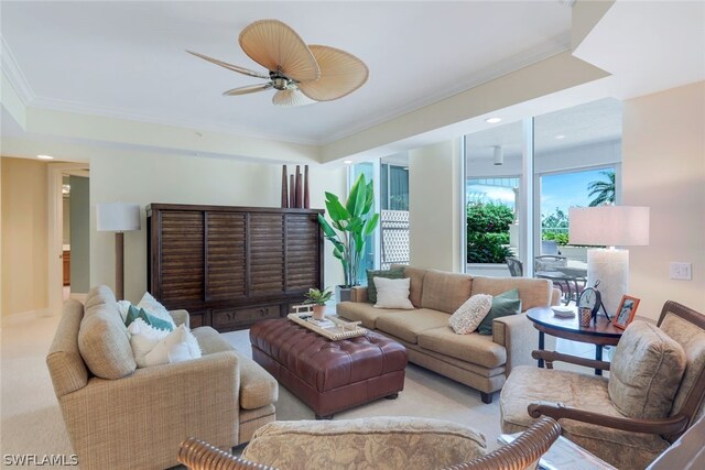 living room featuring ceiling fan, light colored carpet, and ornamental molding