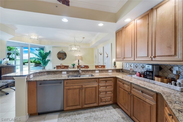 kitchen featuring kitchen peninsula, backsplash, stainless steel dishwasher, a raised ceiling, and sink