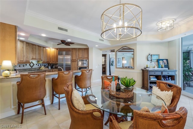 dining room featuring ceiling fan with notable chandelier, light tile patterned floors, and crown molding