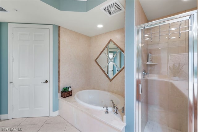 bathroom featuring tile patterned floors and separate shower and tub