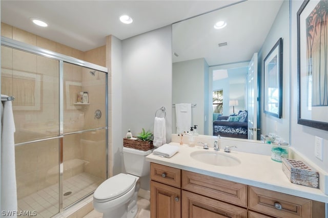 bathroom with walk in shower, vanity, and toilet