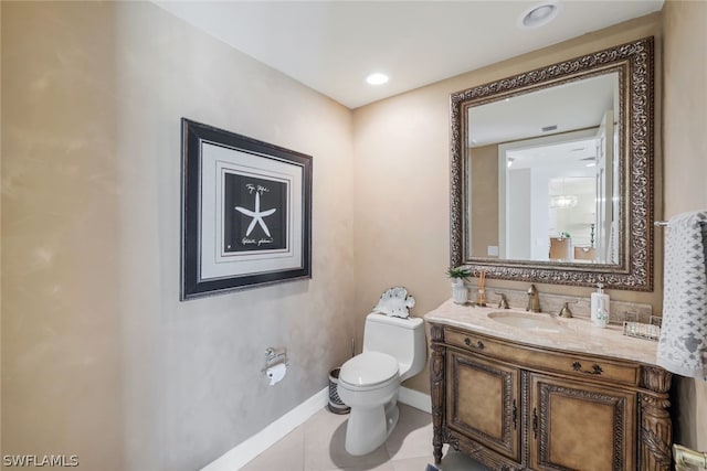 bathroom featuring tile patterned floors, vanity, and toilet