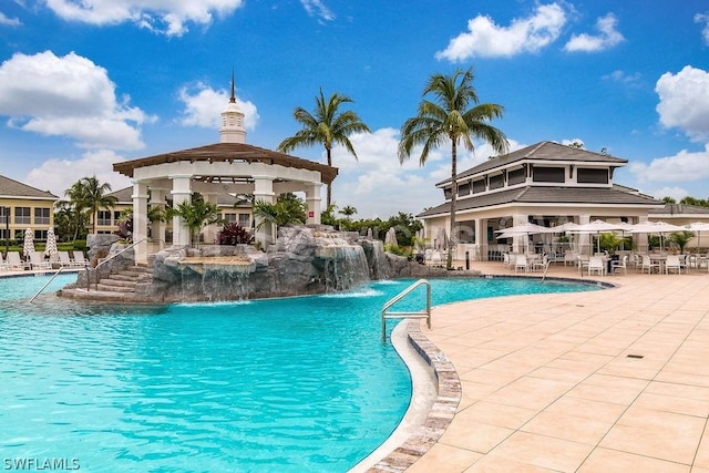 view of swimming pool with a gazebo, pool water feature, and a patio area