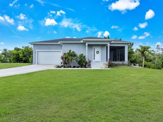 view of front of home featuring a sunroom, a garage, and a front yard