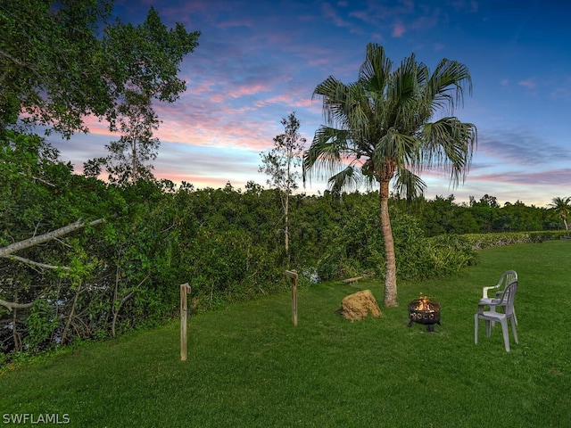 yard at dusk with an outdoor fire pit