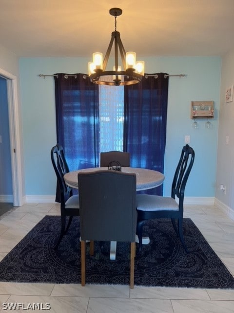 dining space featuring a notable chandelier and light tile flooring