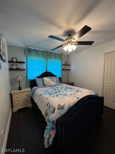 bedroom featuring ceiling fan and dark hardwood / wood-style flooring