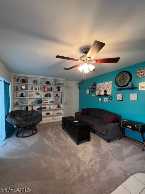 carpeted living room with ceiling fan