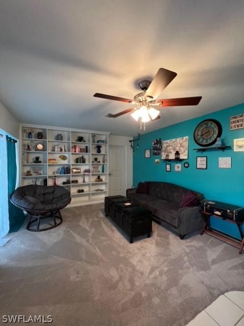 carpeted living room featuring a ceiling fan