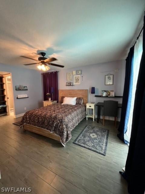 bedroom with wood finished floors, baseboards, and ceiling fan