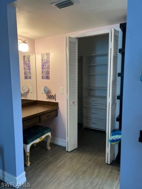 bathroom with visible vents, baseboards, and wood finished floors