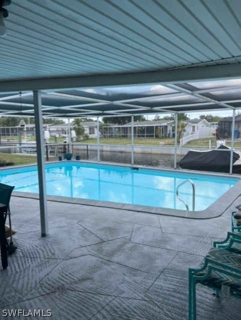 outdoor pool featuring a lanai and a patio