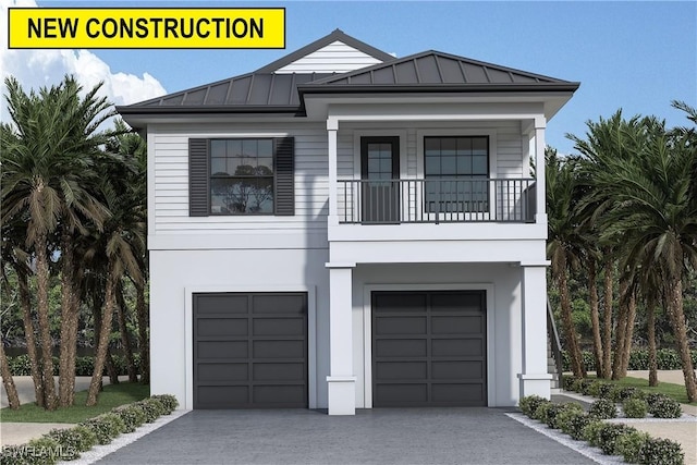 coastal home featuring metal roof, a garage, a balcony, driveway, and a standing seam roof