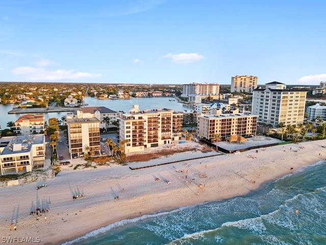 birds eye view of property featuring a water view and a view of the beach