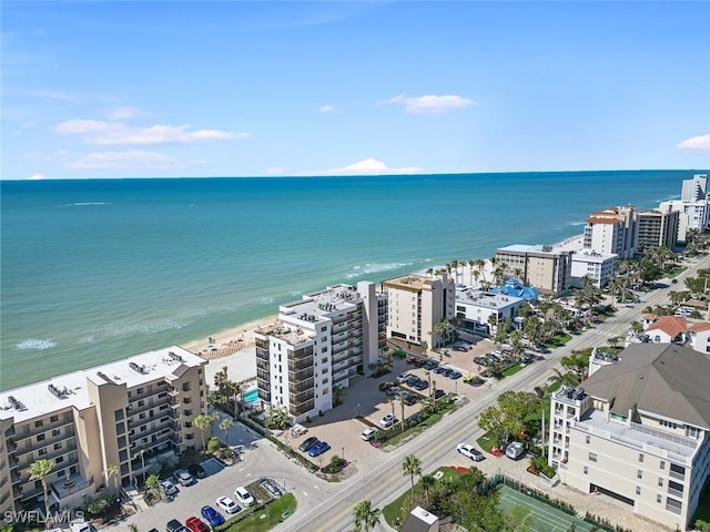 birds eye view of property featuring a water view and a beach view