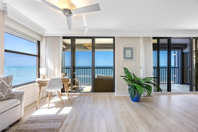 interior space featuring a water view and ceiling fan