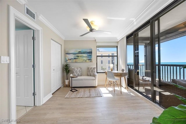 sunroom / solarium featuring ceiling fan, a water view, and a wealth of natural light