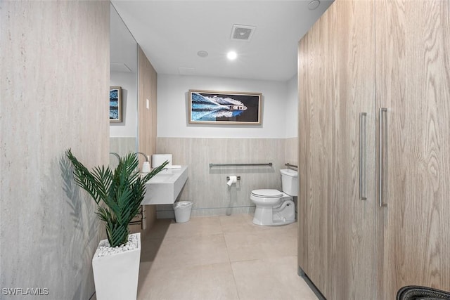 bathroom with toilet and tile patterned floors