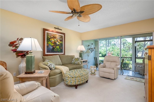 carpeted living room with ceiling fan and a textured ceiling