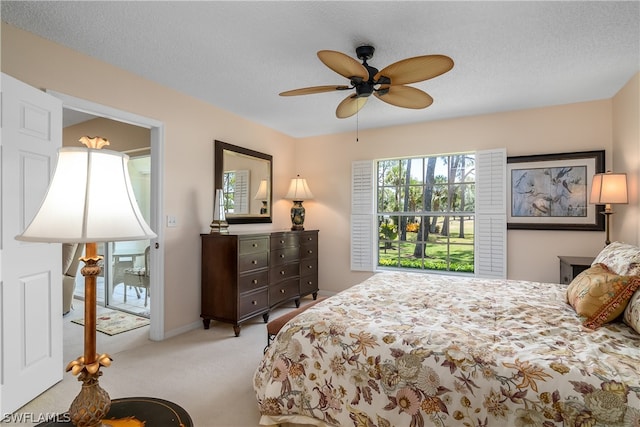 carpeted bedroom with a textured ceiling and ceiling fan