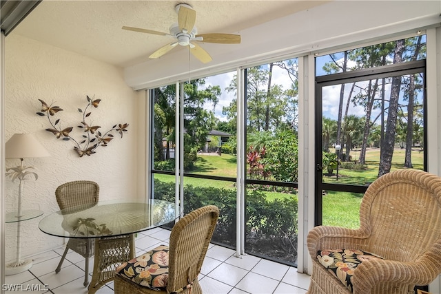 sunroom / solarium featuring ceiling fan