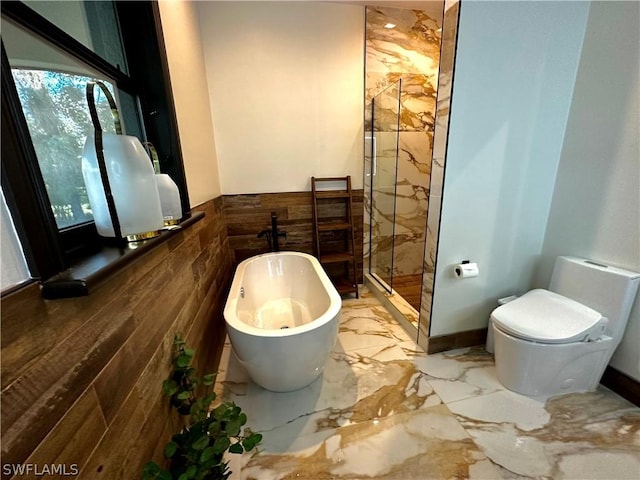 bathroom with plenty of natural light, plus walk in shower, tile walls, and toilet