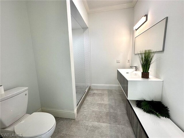 bathroom with vanity, toilet, and crown molding