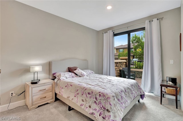 bedroom with access to exterior and light carpet