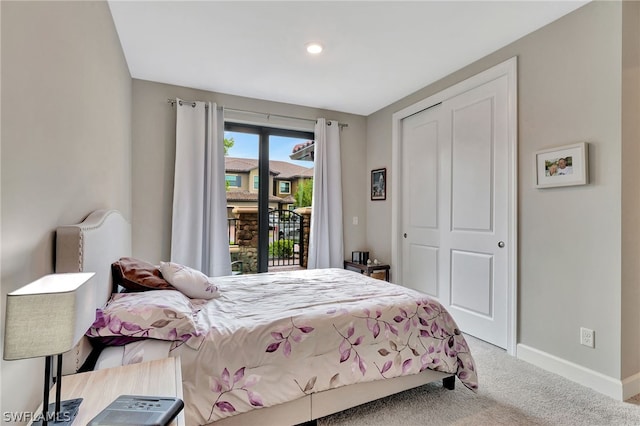 carpeted bedroom with access to outside and a closet