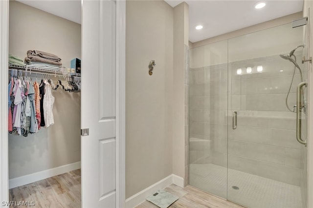 bathroom featuring walk in shower and hardwood / wood-style flooring