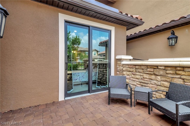 doorway to property with a patio