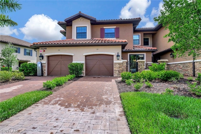 mediterranean / spanish home featuring a garage