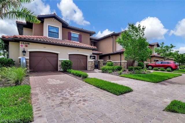 mediterranean / spanish-style house with a garage