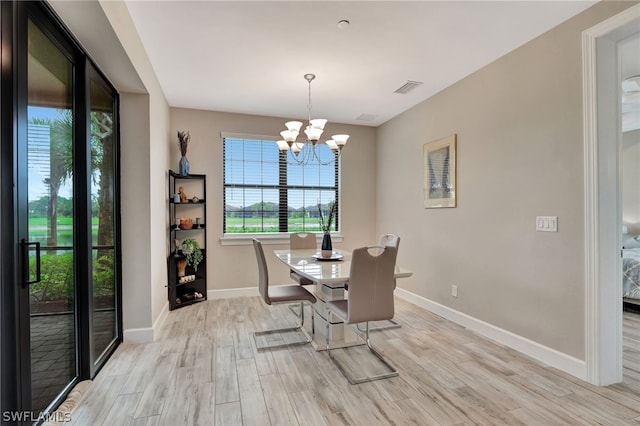 dining space featuring a chandelier and light hardwood / wood-style flooring