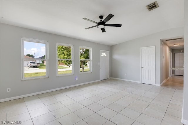 unfurnished room featuring ceiling fan, light tile patterned flooring, and lofted ceiling