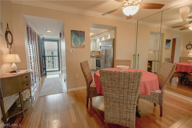 dining space featuring ceiling fan, ornamental molding, and light hardwood / wood-style flooring