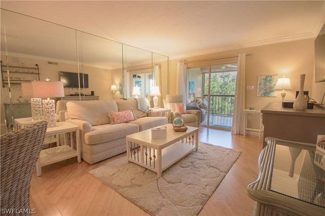 living room with crown molding and light hardwood / wood-style flooring