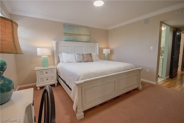 bedroom with light hardwood / wood-style floors and crown molding