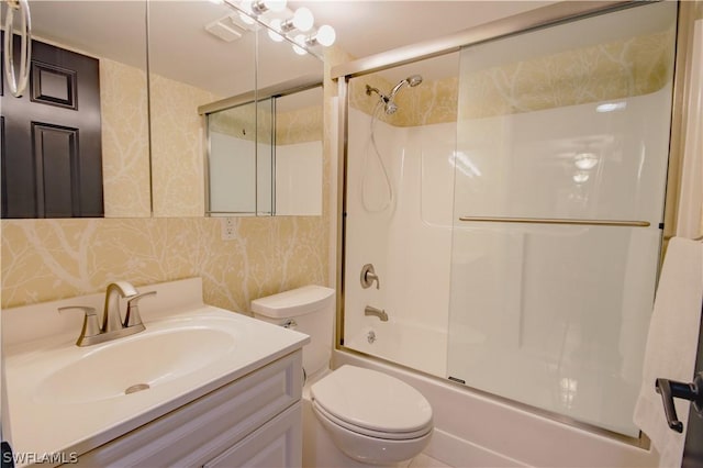 full bathroom featuring vanity, toilet, and enclosed tub / shower combo