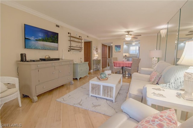 living room featuring ceiling fan, light hardwood / wood-style floors, and ornamental molding