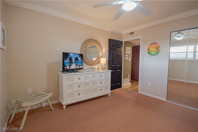 bedroom with ceiling fan, crown molding, and light colored carpet