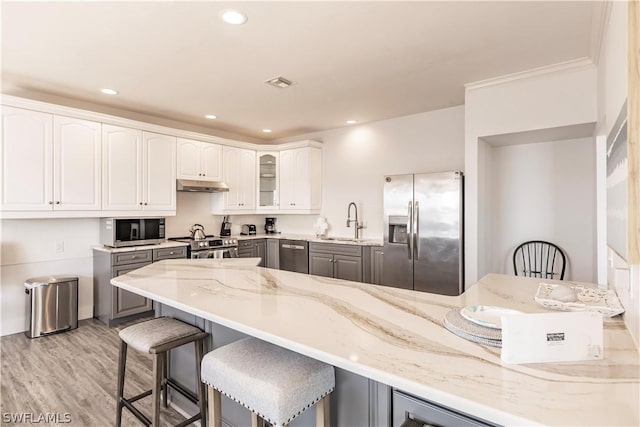 kitchen with sink, white cabinets, gray cabinets, and stainless steel appliances