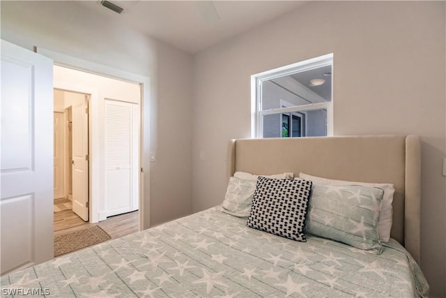 bedroom featuring hardwood / wood-style flooring and ensuite bathroom