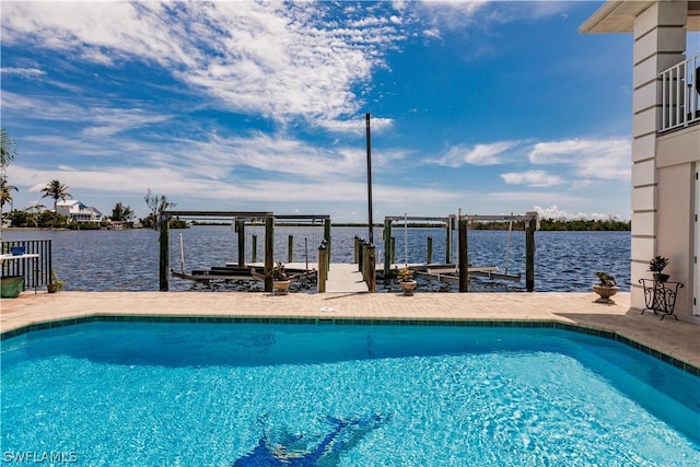 view of pool with a boat dock and a water view