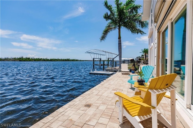 dock area with a patio area and a water view